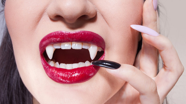 Sexy vampire. Women's lips with red lipstick.