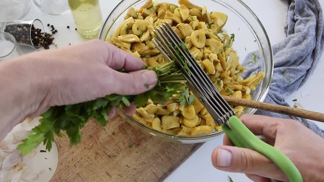 Personal perspective of woman hands cooking Amanita caesarea (known as Caesar's mushroom)