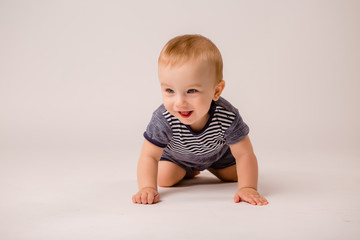 baby boy with blue eyes 7 months on white background isolate, space for text