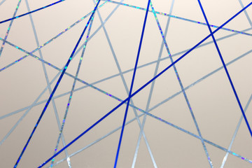 This is a photograph of a geometric design created using dark and light Blue tape applied onto a White paper