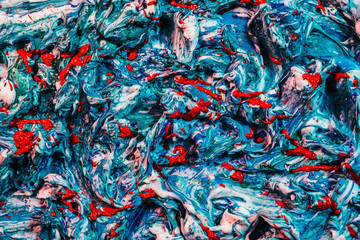 Colorful abstract art background. Blue and white acrylic paint mix with vibrant red splash.