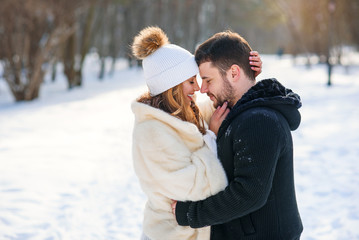 A beautiful young girl and a handsome boyfriend gently leaned against each other face to face. Love story and romantic concept.