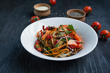 Eggplant, pepper and carrot salad. Korean eggplant salad. White background. Vegetarianism. View from above. Copy space.