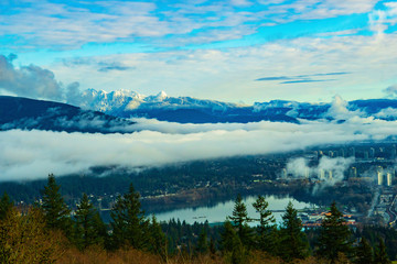 Inversion over Burrard Inlet at Port Moody with backdrop of snow-covered mountains