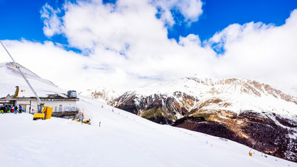 Beautiful mountains in winter, slopes and pistes with ski lifts, ski and snowboard holidays, Livigno village, Italy, Alps