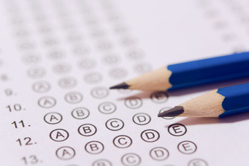 Pencil on answer sheets or Standardized test form with answers bubbled. multiple choice answer sheet