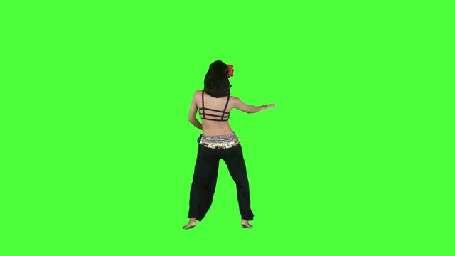 Slow motion of attractive young woman dancing zumba in the studio with green screen background