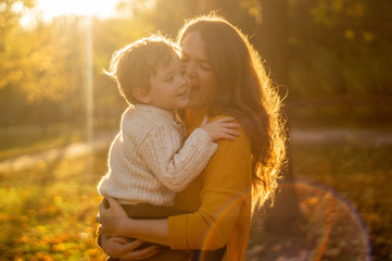 Mother and son walking in the Park and enjoying the beautiful autumn nature