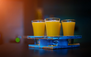 A set of yellow shots in one row