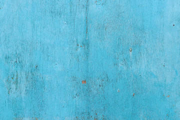 Fototapeta na wymiar Texture of an old cracked veneer sheet painted in blue