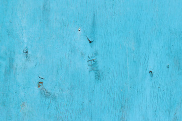 Texture of an old cracked veneer sheet painted in blue