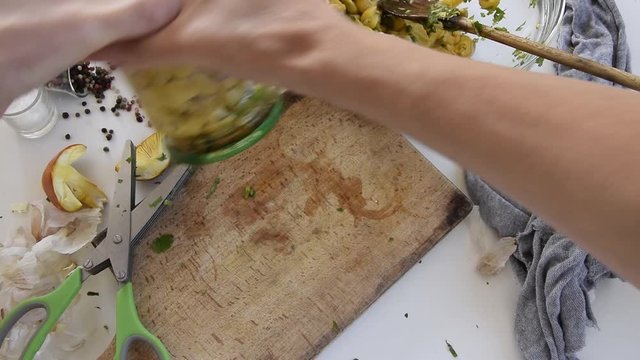 Personal perspective of woman hands preparing Amanita caesarea (known as Caesar's mushroom). Put the mushrooms in jars in oil
