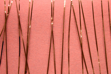 This is a photograph of a geometric design created using Rose gold tape applied onto a Pink paper