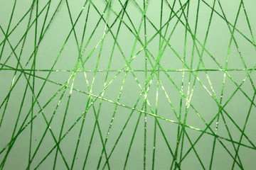 This is a photograph of a geometric design created using metallic green tape applied onto a Green paper