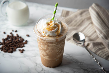 caramel frappuccino with wipped cream on marble table