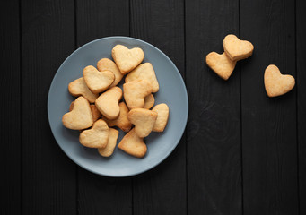 cookies with a heart in a plate on a black background