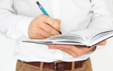 A man holds in his hands a notebook, notebook, diary and pen. Business concept isolated on white background.