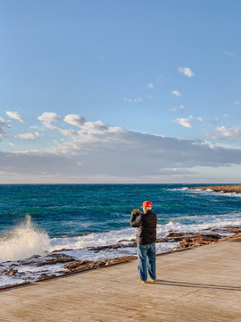 Man capturing photo of beach