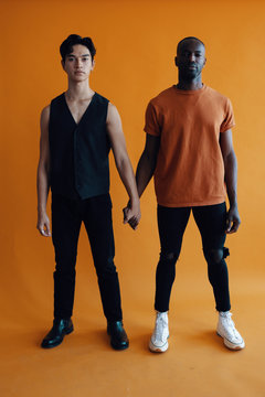 Studio portrait of men holding hands