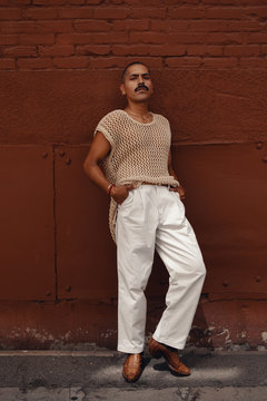 Portrait of man with mustache wearing open crochet top