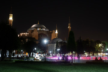 Fototapeta na wymiar Hagia Sophia Mosque with night scene and street lights. Shooting from the edge of the pool.