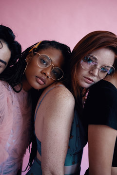 Studio portrait of group of friends leaning on each other in a row