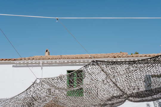 Camo Netting Hanging Between Houses