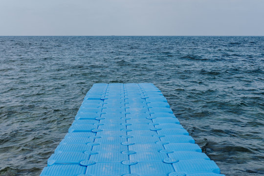 Fototapeta Blue plastic pier in sea