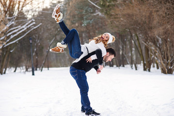 young loving couple on natural winter background. New Year and Christmas.
