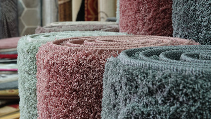 Carpets variety selection rolled up long rugs shop store