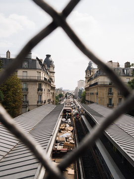 Roof of Paris metro at Passy Station seen through chainlink fence