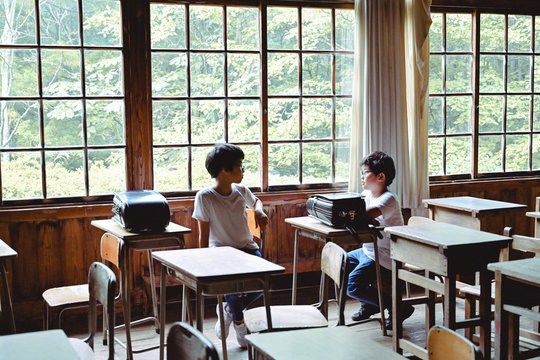 Students looking each other in classroom