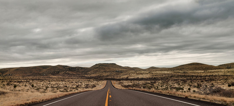 Empty road in landscape with storm clouds