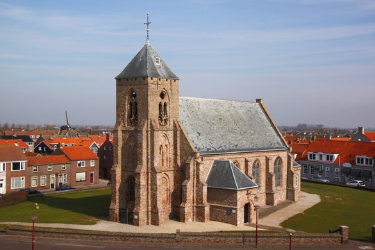The Catharinakerk church in Zoutelande village with its gothic brick tower in Veere, Zeeland, the Netherlands