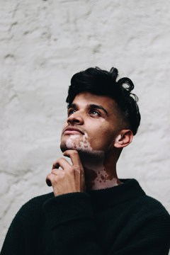 Portrait of young man hand under chin