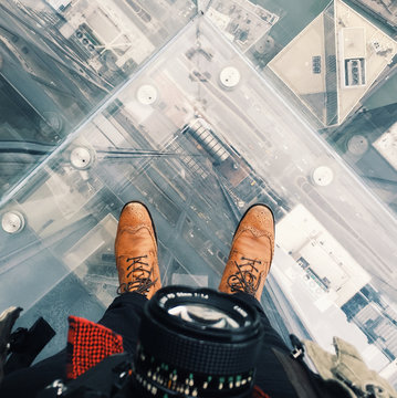 Man standing on roof of skyscraper