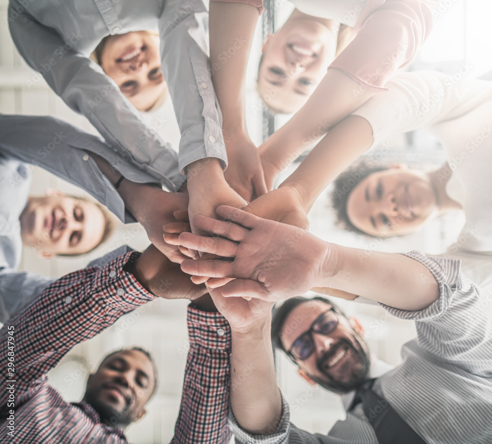 Wall mural stack of hands. unity and teamwork concept.
