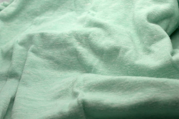 This is a photograph of textured light Green fabric