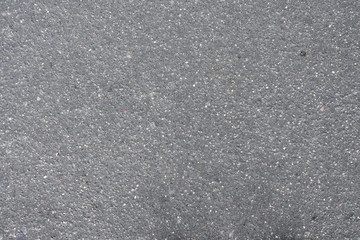 Texture of grey asphalt, bitumen and stones, small inclusions