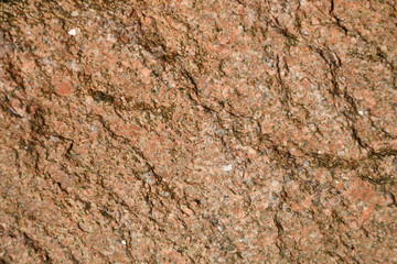 Texture of the destroyed stone, pink granite, small inclusions
