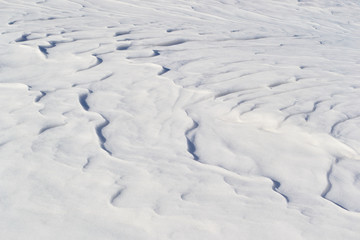 Snow ripples blown by the wind - simple, minimal, abstract pattern background.