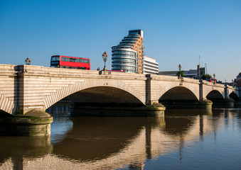 Fototapeta premium Putney bridge reflected in Thames river water in a sunny day - London, England