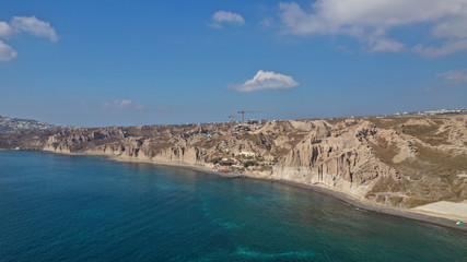 Aerial drone photo of amazing shape giant volcanic rock formations in Vlychada beach, Santorini island, Cyclades, Greece