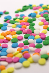 Fototapeta na wymiar This is a photograph of colorful round sprinkles isolated on a White Background
