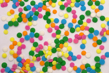 This is a photograph of colorful round sprinkles isolated on a White Background