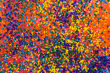 This is a background of colorful neon colored round sprinkles background