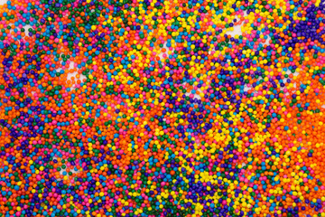 This is a background of colorful neon colored round sprinkles background