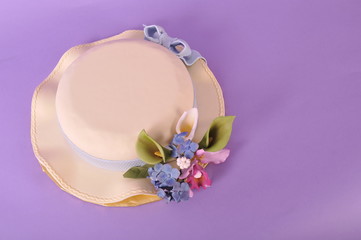 Easter bonnet cake isolated on pastel lilac purple background with copy space