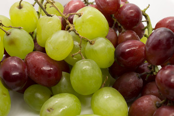 Naklejka na ściany i meble This is a photograph of Green and Red Grapes isolated on a White background