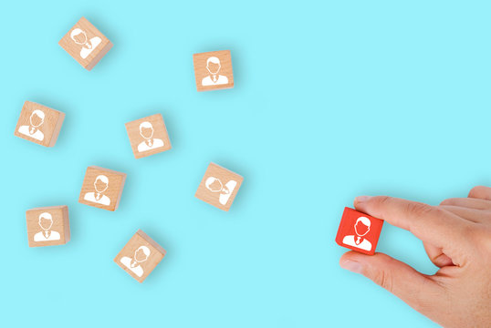 business woman chooses staff leader on wooden cube